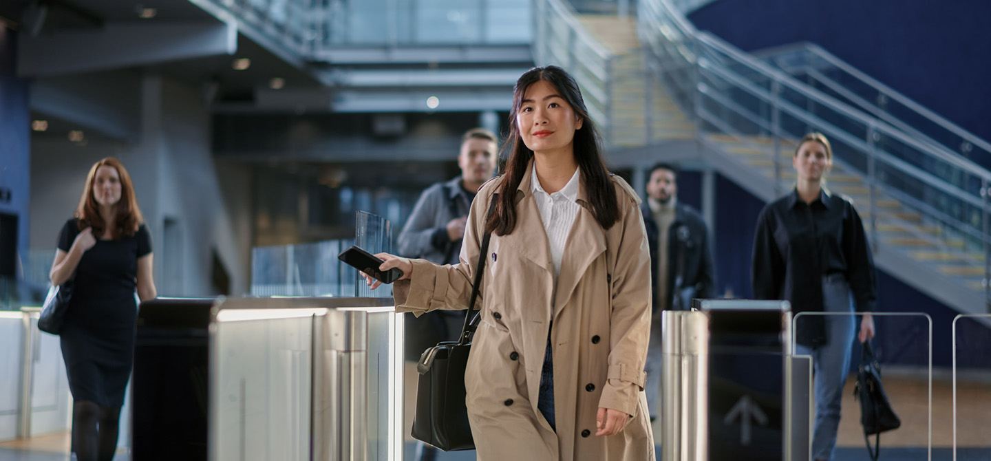 Woman walking through turnstiles